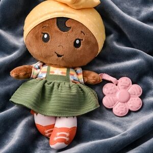 Adorable Brown Doll with Green Dress and Pink Flower Accessory